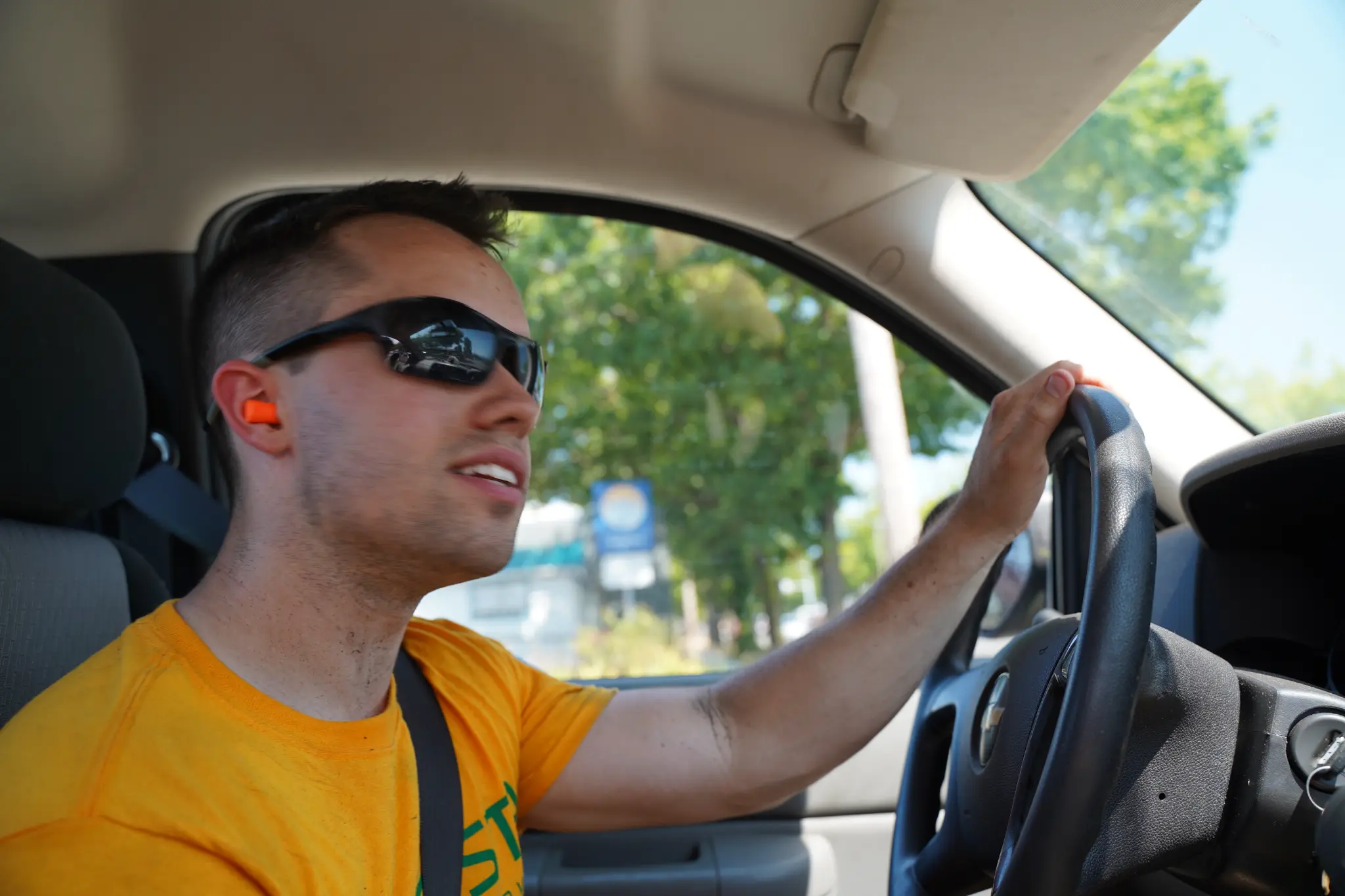 Mike Andes driving to a lawn care job